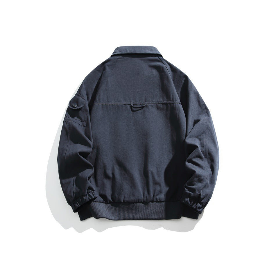 Back view of a dark navy jacket with a pointed collar, sleeve pocket, elastic cuffs and ribbed hem.