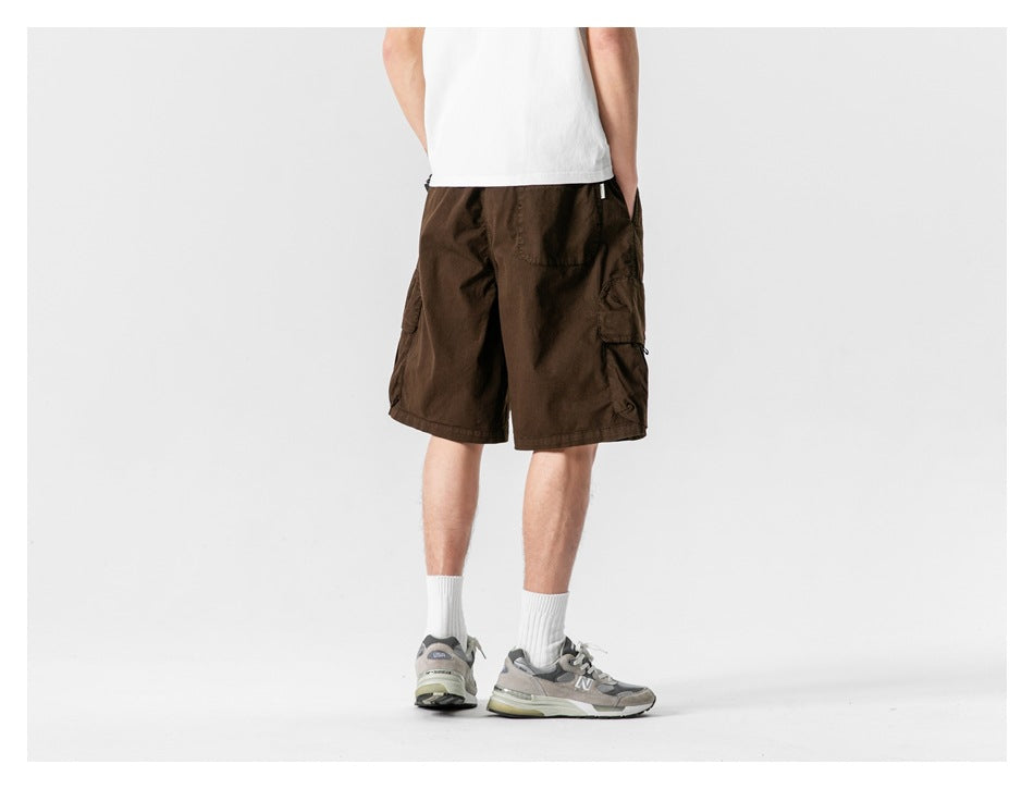 Back view of model wearing coffee brown cargo shorts with back pocket and side cargo pocket