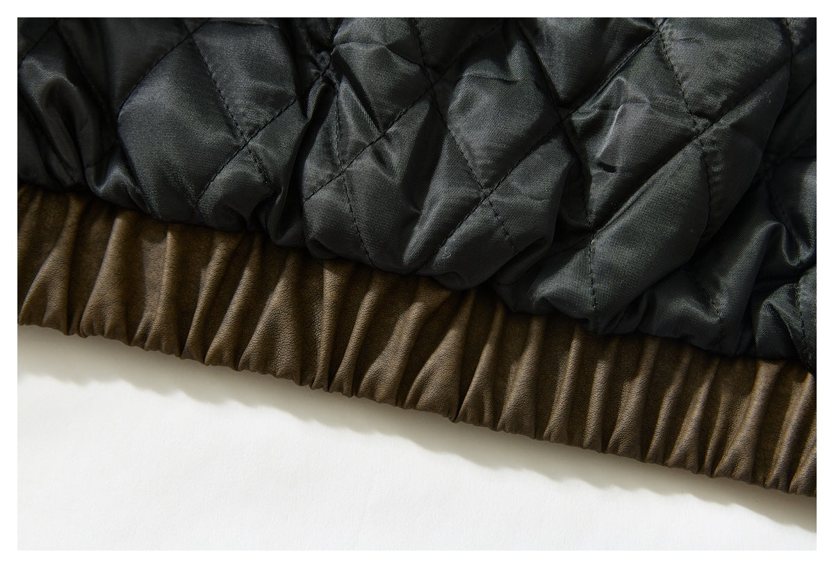 Close-up of black quilted lining above the brown jacket's gathered hem.