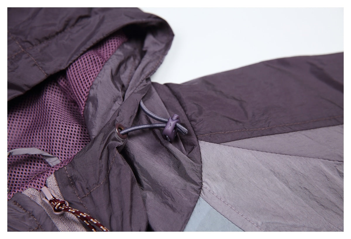 Close-up of a purple-gray jacket hood with mesh lining and an adjustable drawcord toggle.