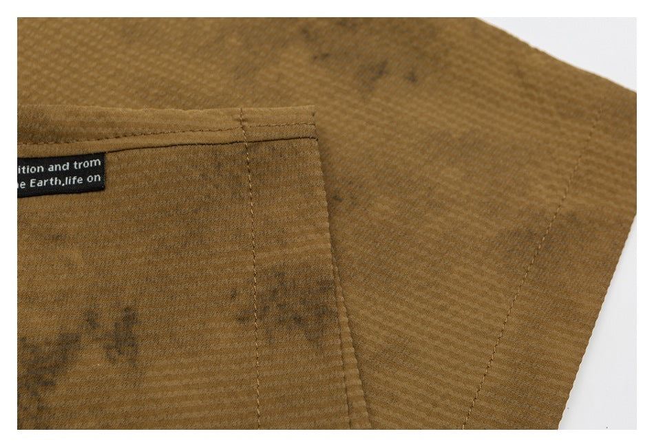 Close-up of brown textured garment fabric with stitched seams and a partially visible black label.