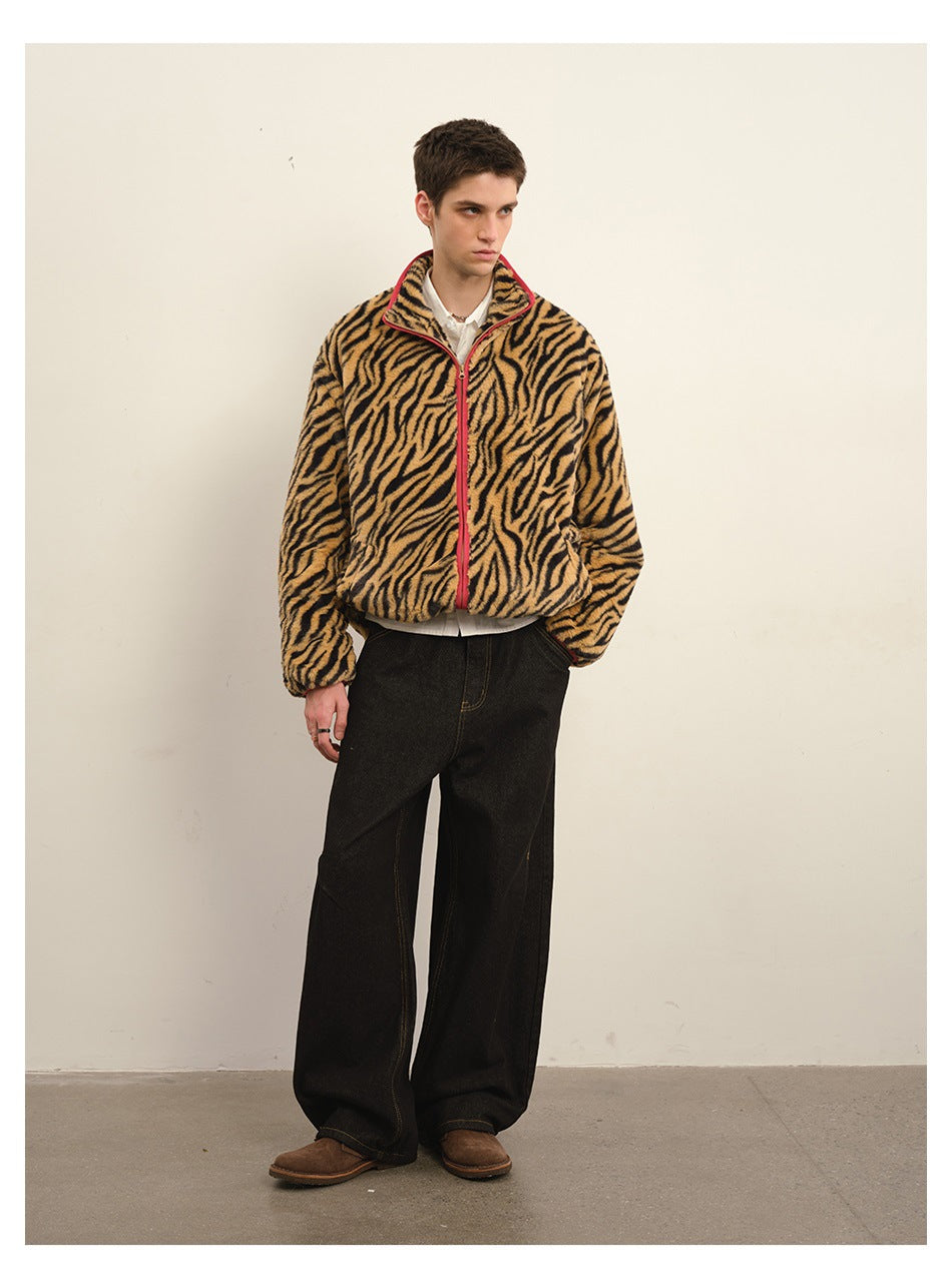 Model wearing black wide-leg jeans with a tiger-stripe fleece-like zip jacket and brown shoes, front view