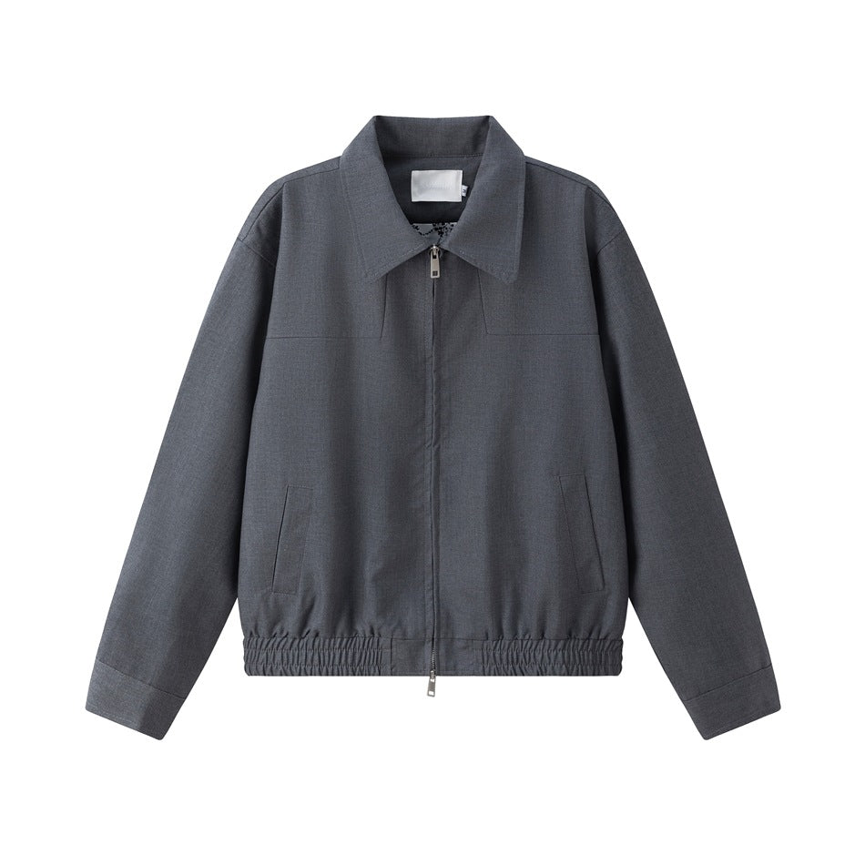 Gray zip-front collared jacket flat lay with chest yoke seams, slanted pockets and elastic hem