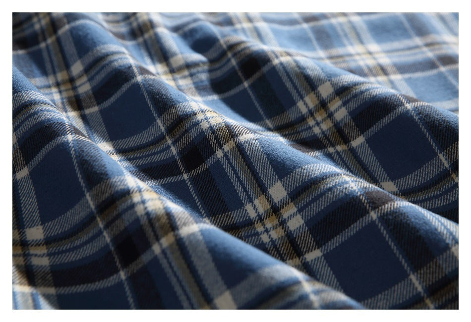 Textured blue, navy, and cream plaid fabric shown in gently rippling folds.