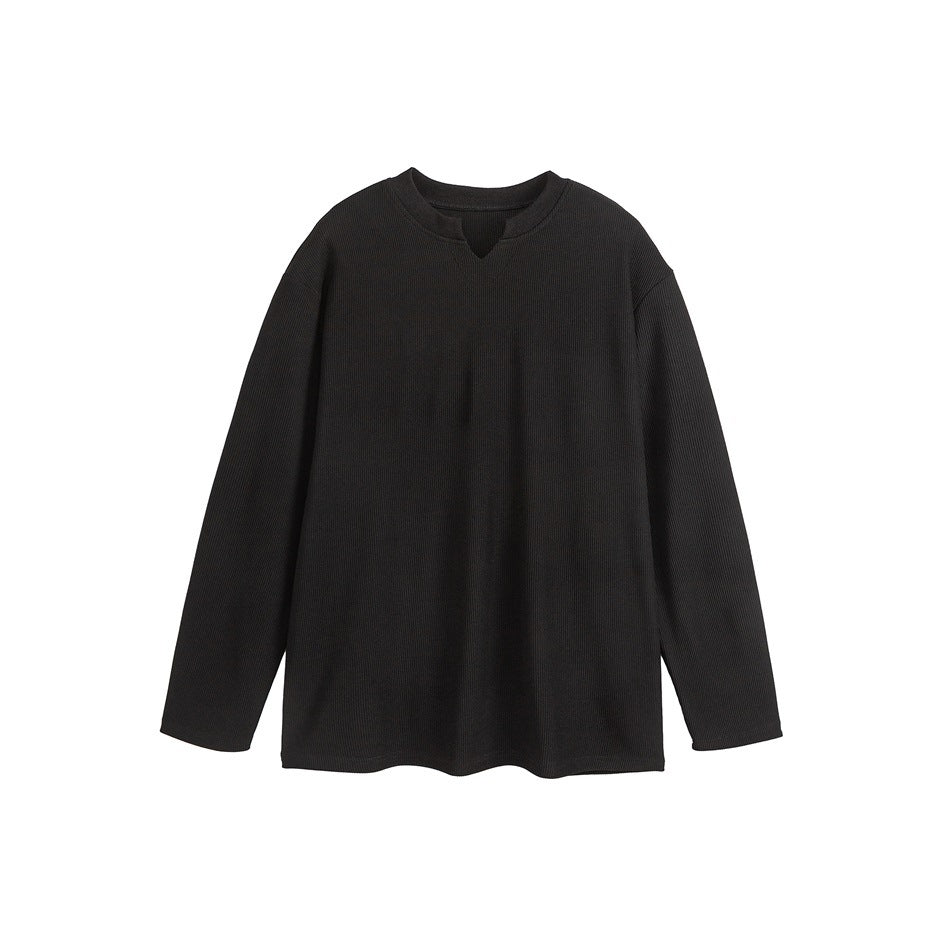 Black long-sleeve ribbed top with notched V-neck, flat lay on white background