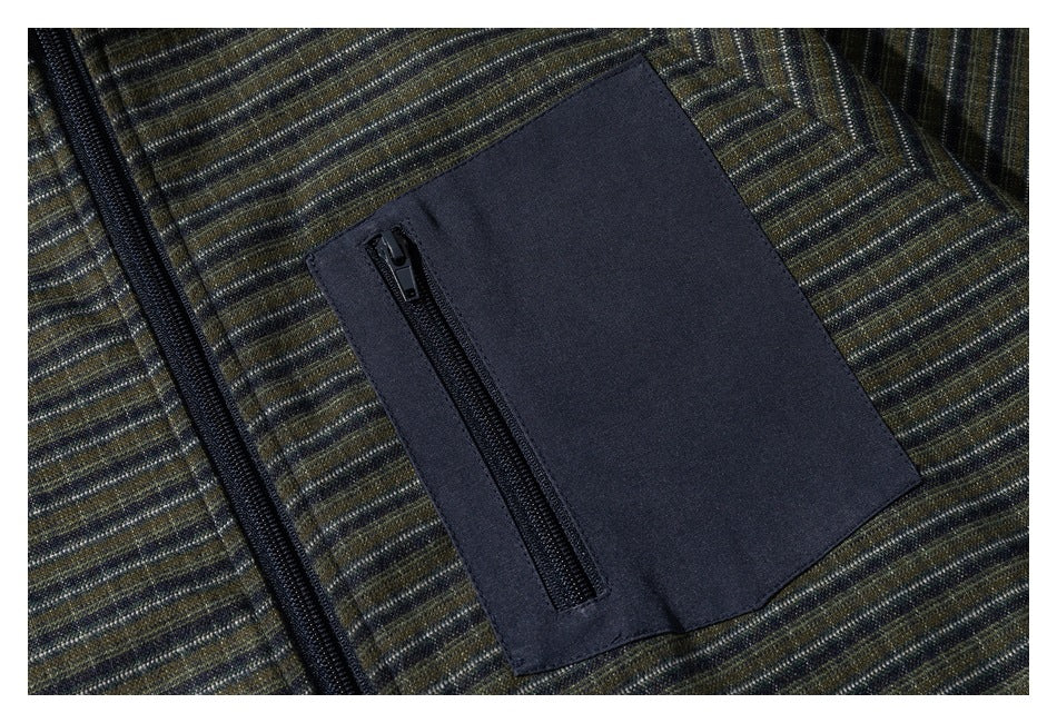 Close-up of a navy patch pocket with a vertical zipper on the striped jacket.