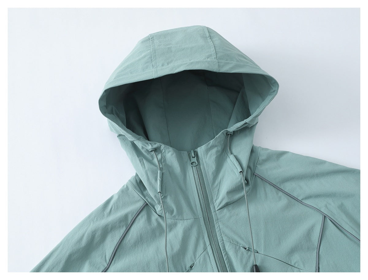 Close-up of a pale aqua jacket hood and upper front, showing drawcords, zipper and contrast piping.