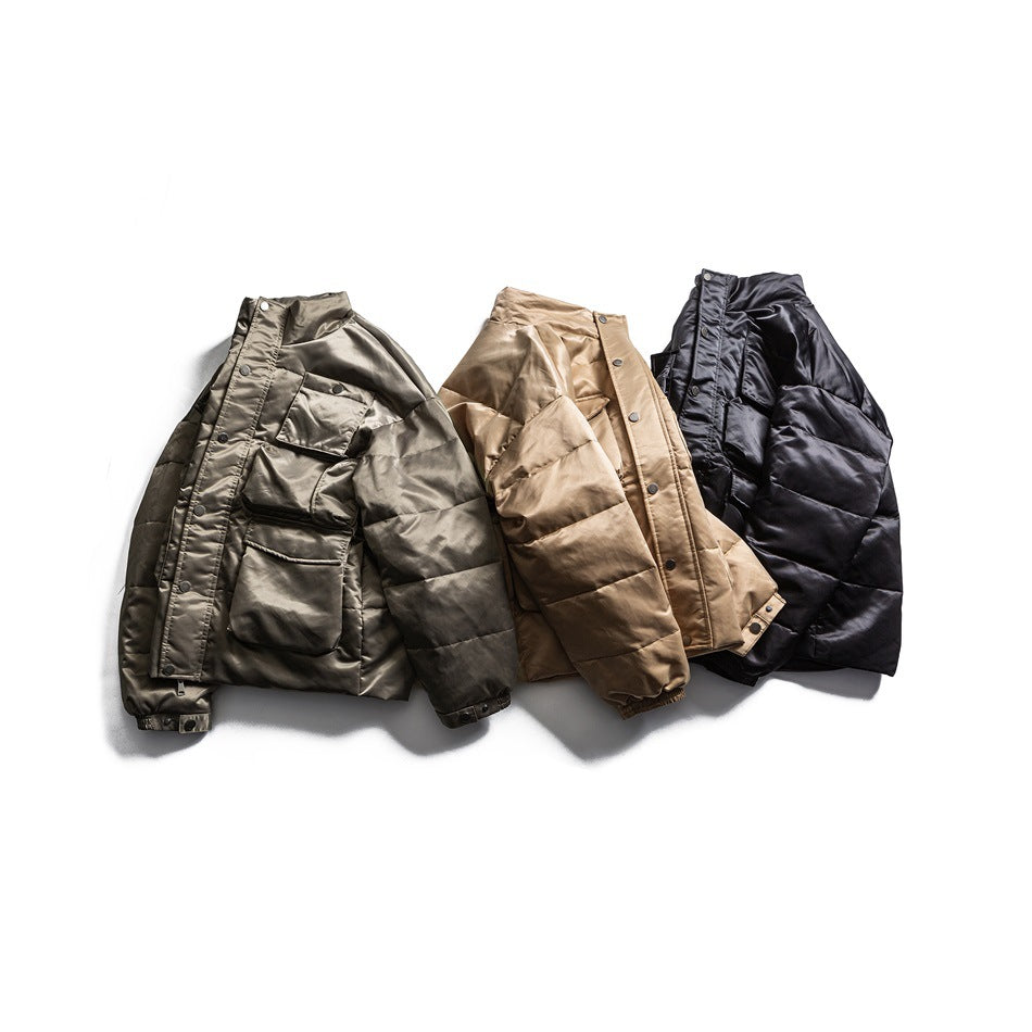 Three padded jackets arranged together in olive gray, tan, and black, showing their fronts.