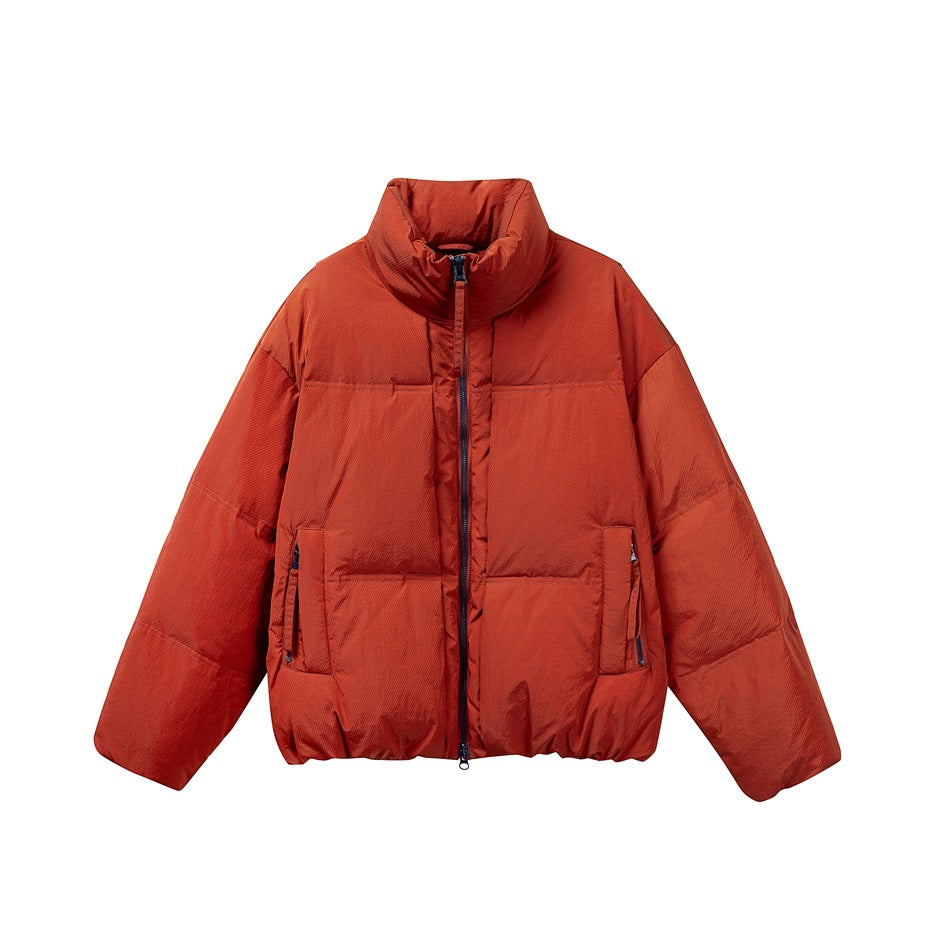 Rust red puffer jacket with stand collar and navy front zipper, flat front view