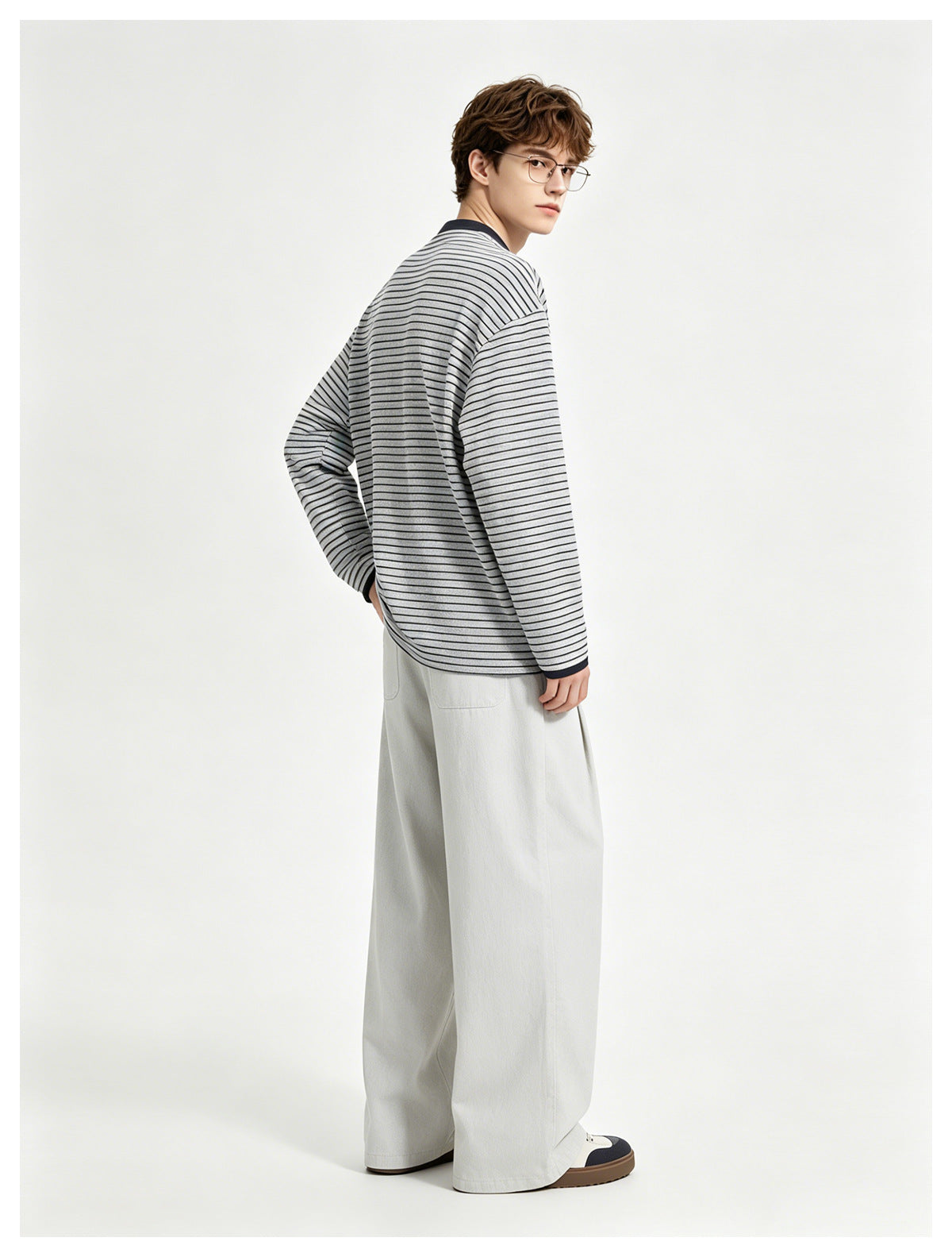 Model shown from the back wearing a light gray and navy striped long-sleeve shirt with dark collar and cuffs.