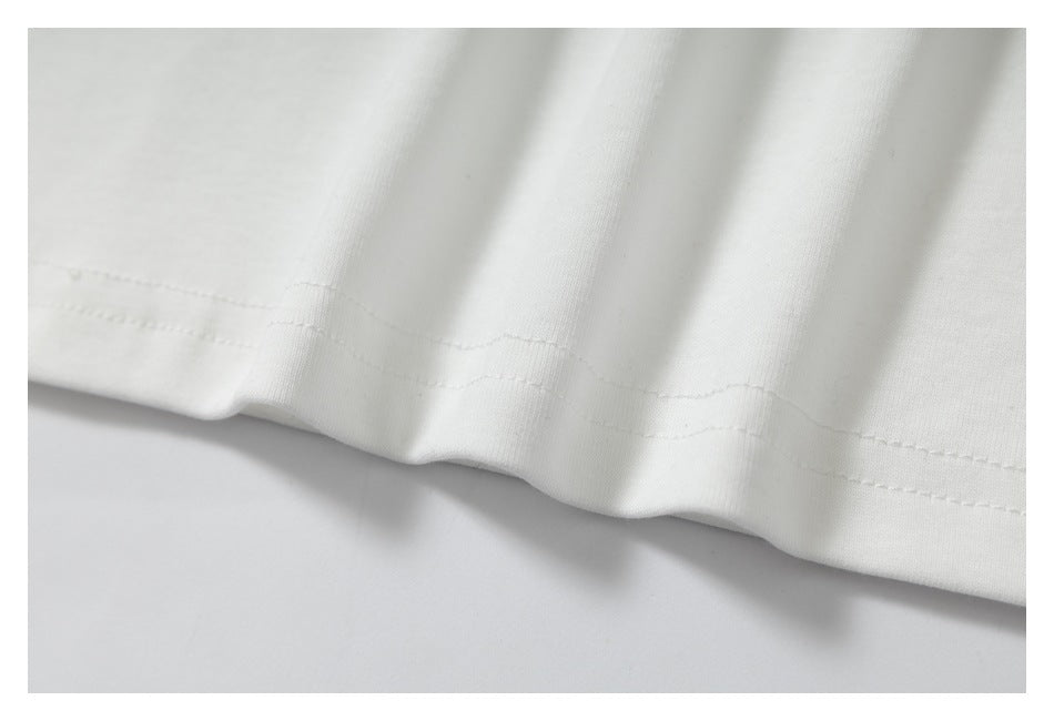 Close-up of the white garment's double-stitched hem.
