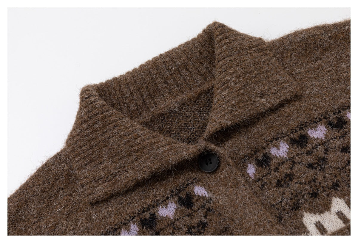 Close-up of a brown knit cardigan's pointed collar, dark button, and lilac patterned band.