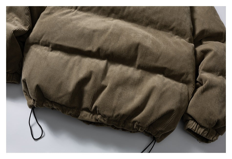 Close-up of the olive-brown corduroy jacket's gathered hem and adjustable drawcords.