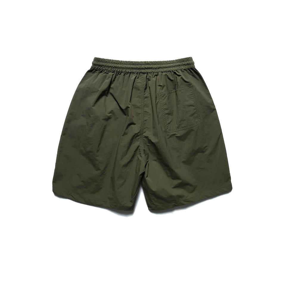 Army green shorts back view with elastic waistband and a patch pocket on one side