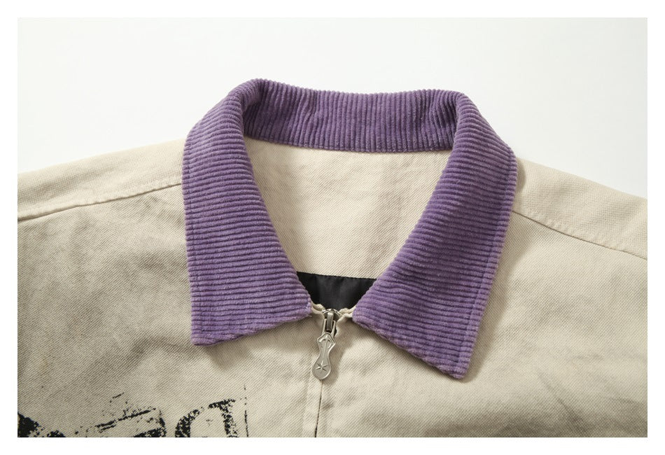 Close-up of the jacket’s ribbed purple collar, metal zipper, and cream fabric.