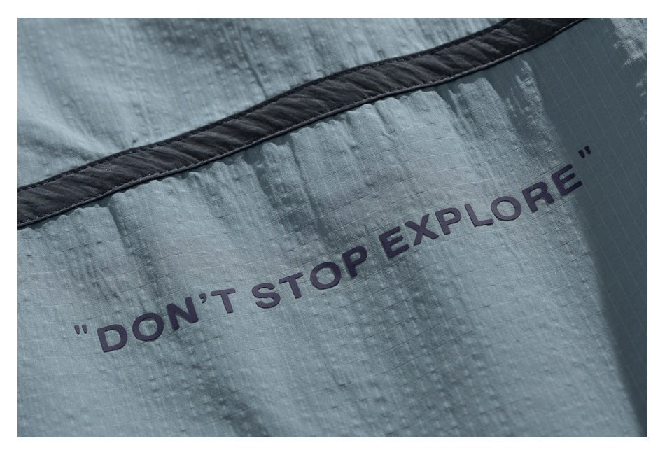 Close-up of the blue-gray garment printed with the phrase “DON'T STOP EXPLORE.”