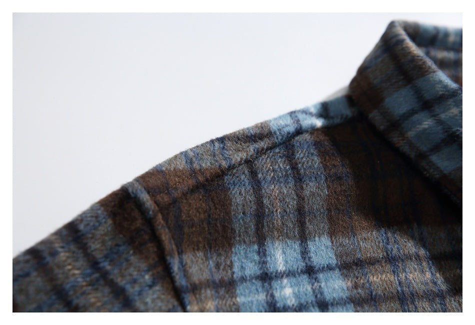 Close-up of the plaid shirt's shoulder seam and collar edge.