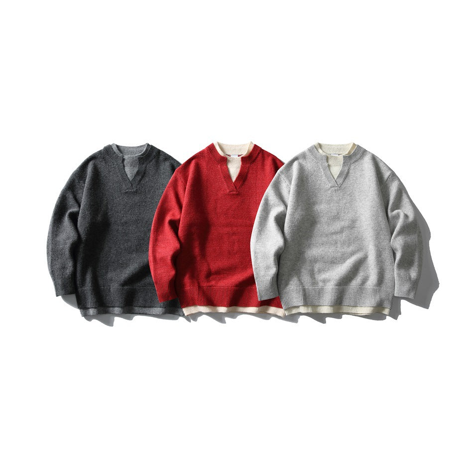 Three V-neck knit sweaters shown from the front in charcoal, red, and light gray, each layered over cream knit.