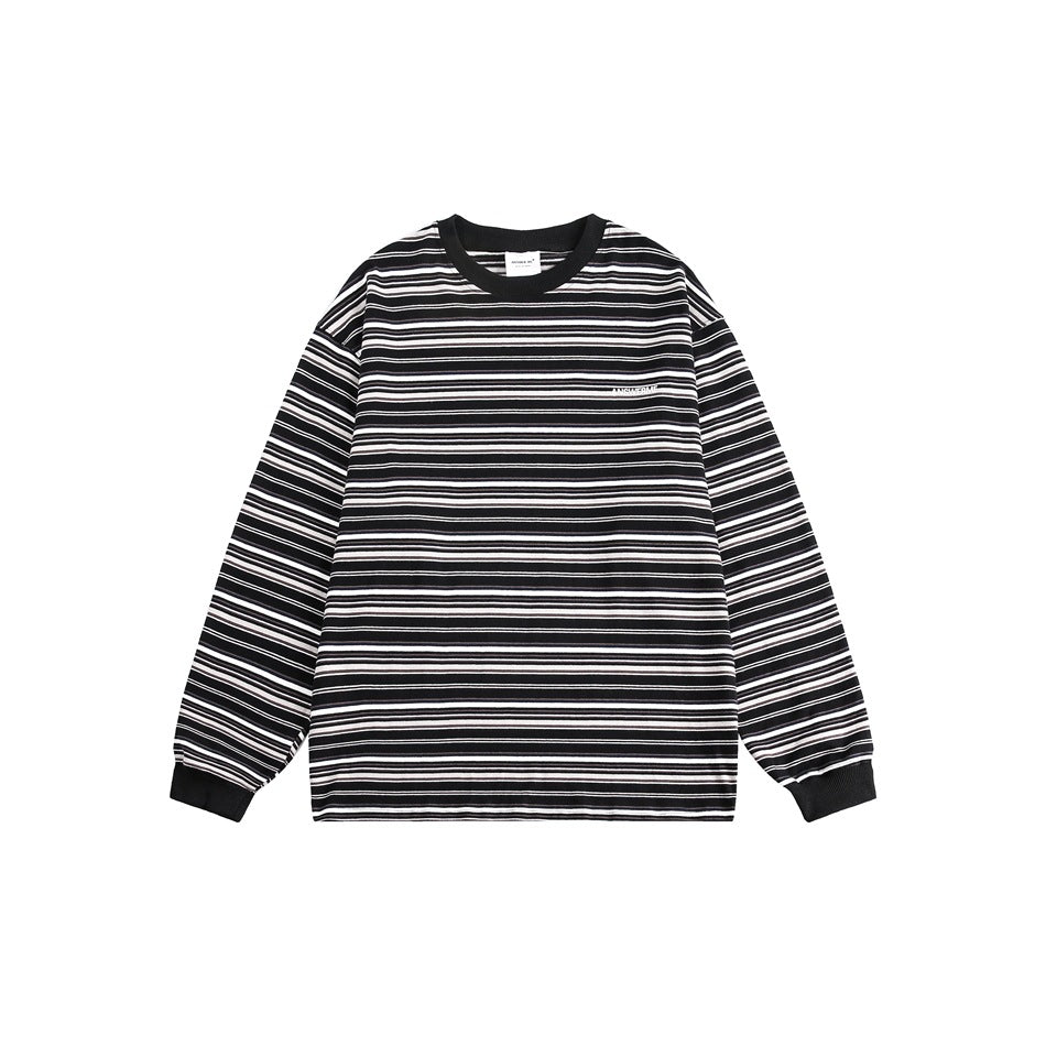 Black, white and gray horizontal-striped long-sleeve crew neck top with black ribbed collar and cuffs, flat lay front
