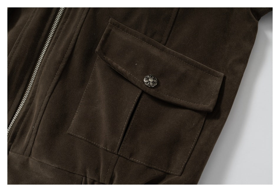 Close-up of a dark brown jacket's flap pocket with a decorative metal button.