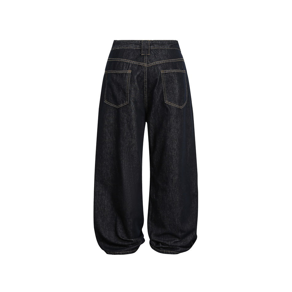 Back view of dark indigo wide-leg jeans with two patch pockets and contrast stitching.