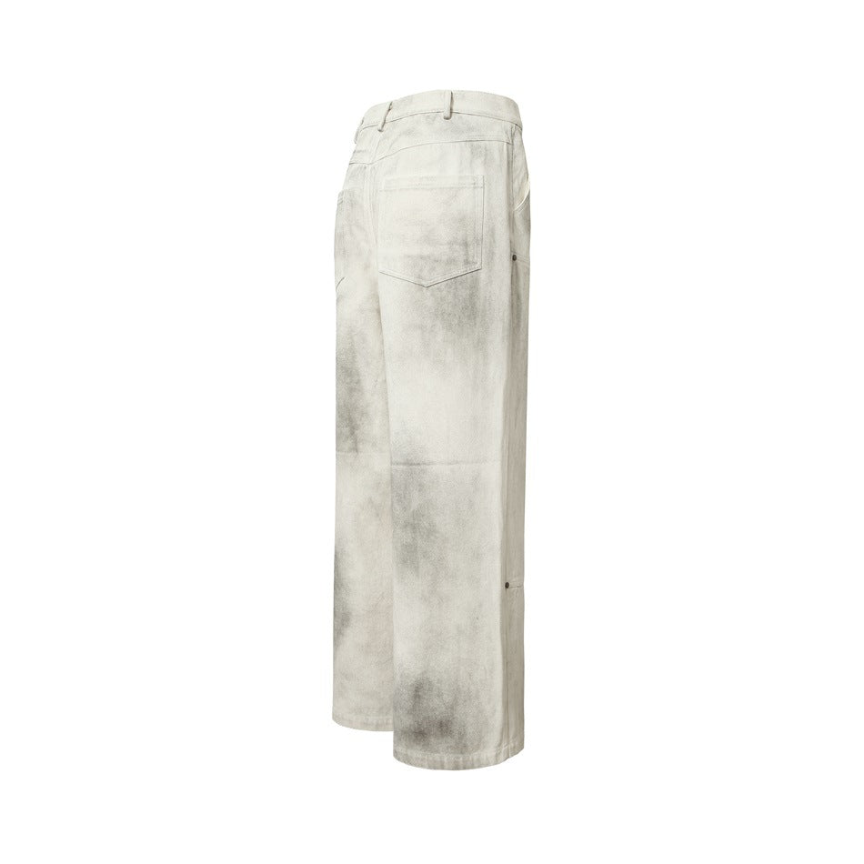 Rear view of off-white wide-leg pants with gray mottling, belt loops, a back pocket, and stitched leg panels.