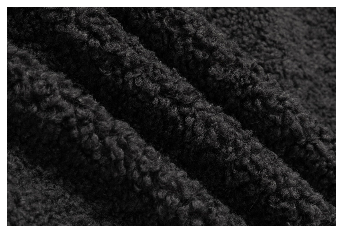 Macro close-up showing the thick, irregular loop texture of charcoal fabric.
