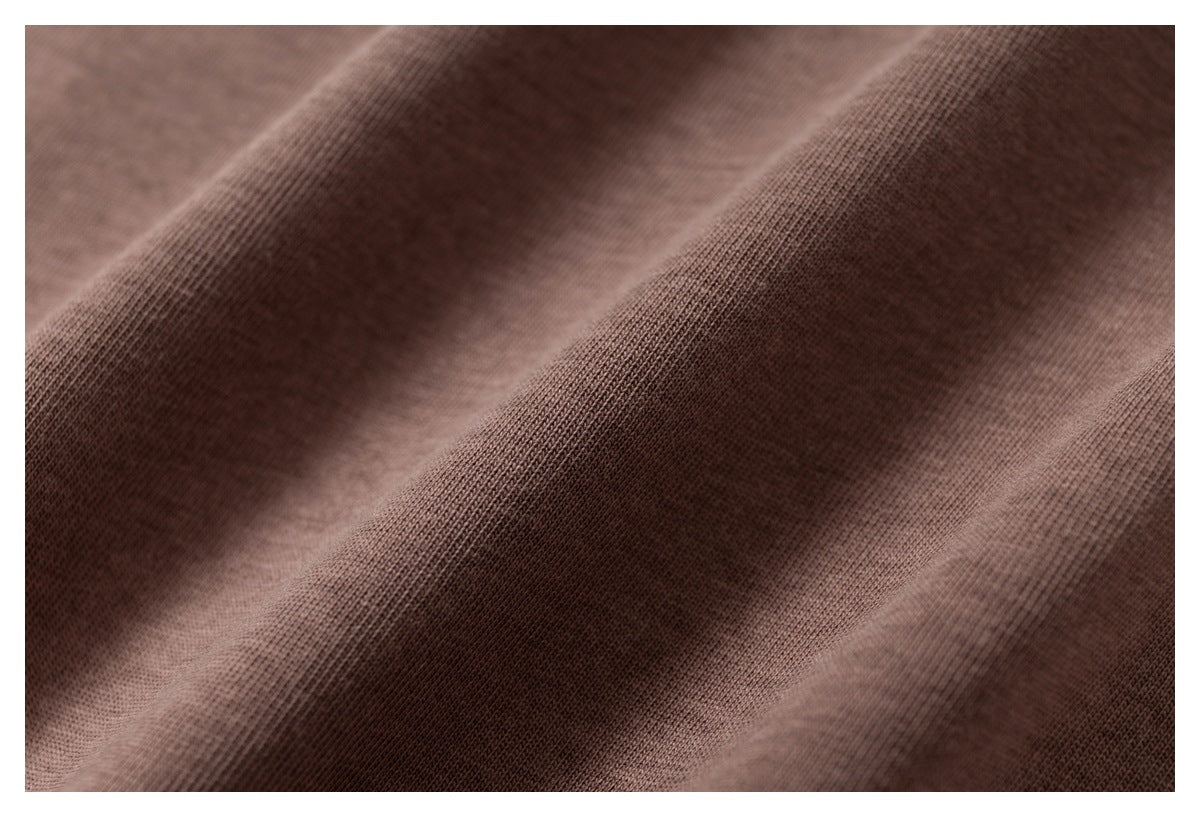 Close-up of draped brown fabric showing its fine knit texture.