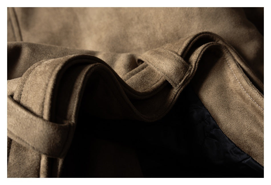 Close-up of a taupe-brown coat showing layered lapels, stitching, a belt loop, and dark lining.