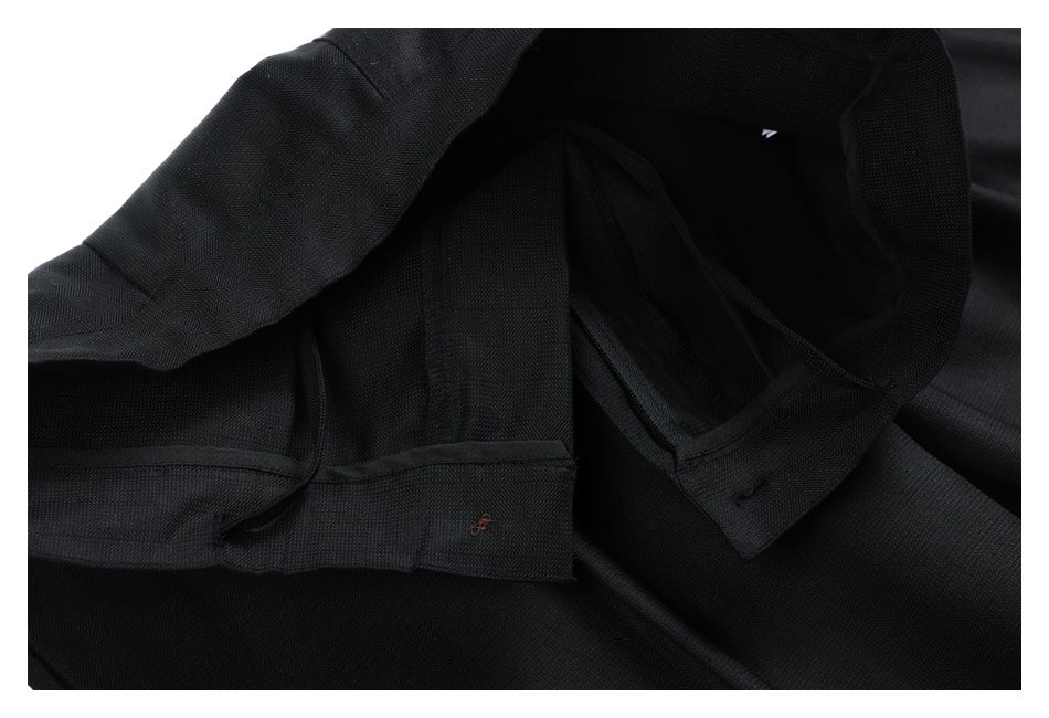 Interior close-up of black trousers showing the waistband lining and inner seams.