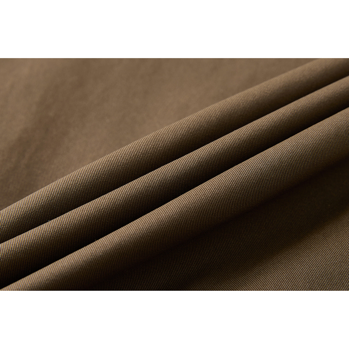 Close-up of brown fabric folded to show its fine woven surface.