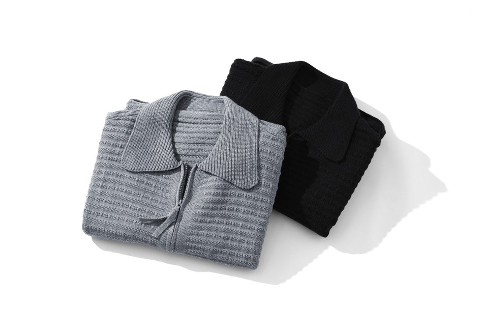 Folded textured collared cardigans in light gray and black, with front zippers visible.