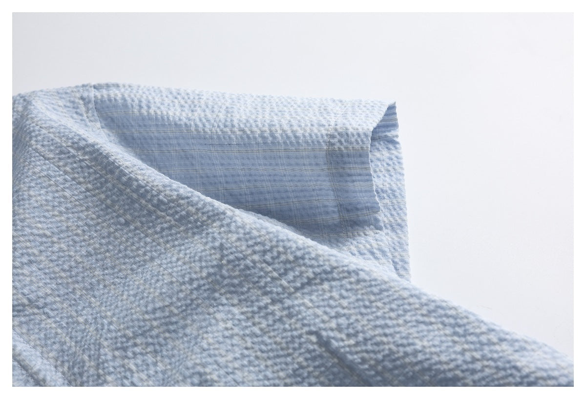 Close-up of the pale blue shirt's collar and upper back yoke.