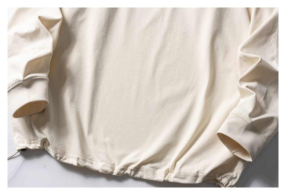 Cropped flat-lay front view of an ivory long-sleeve top with ribbed cuffs and a gathered drawcord hem.