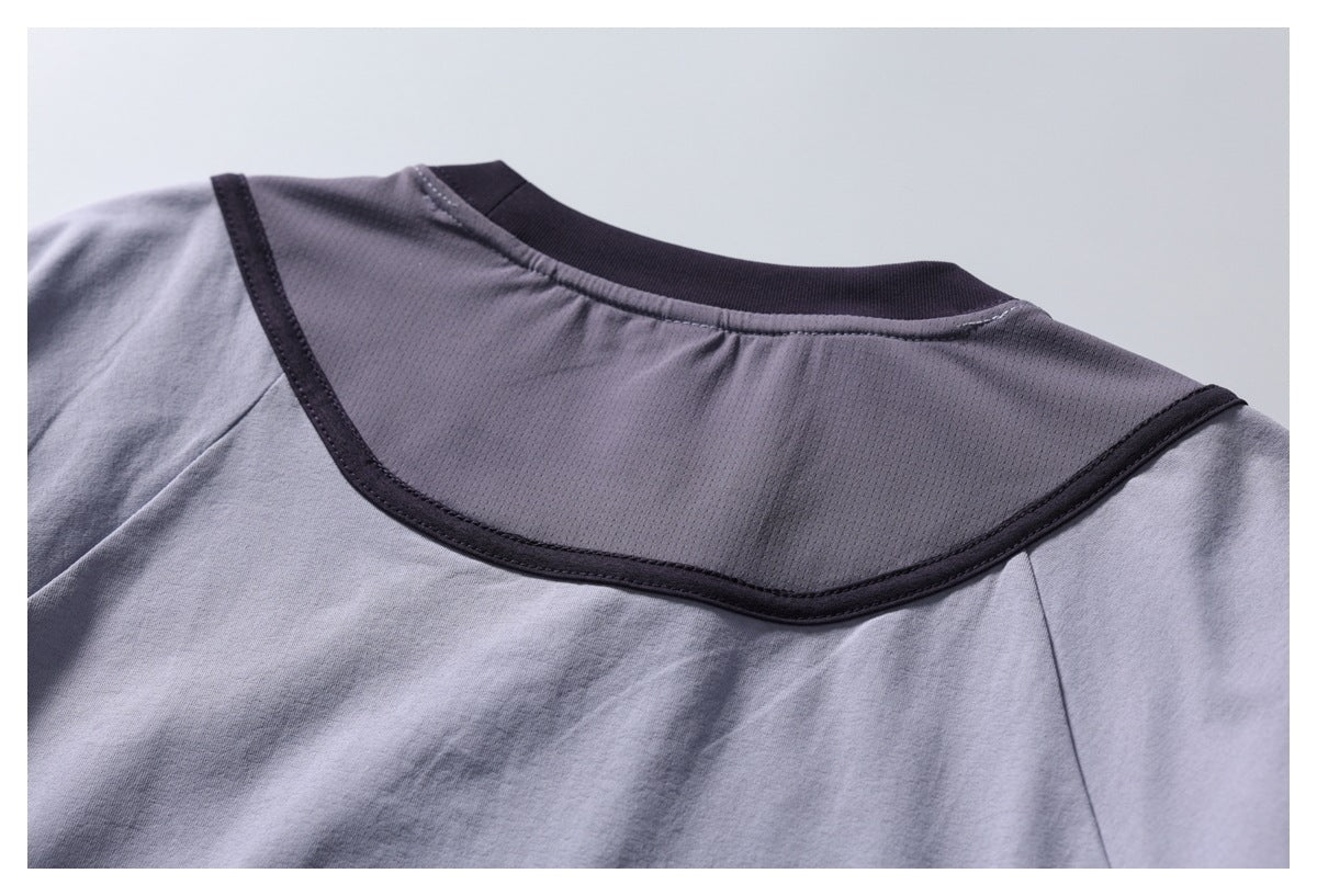 Close-up of the shirt back, showing a gray mesh yoke with dark curved trim.