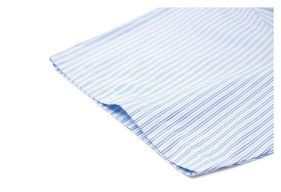 Close-up of the hem and stitching on white fabric with fine blue stripes.
