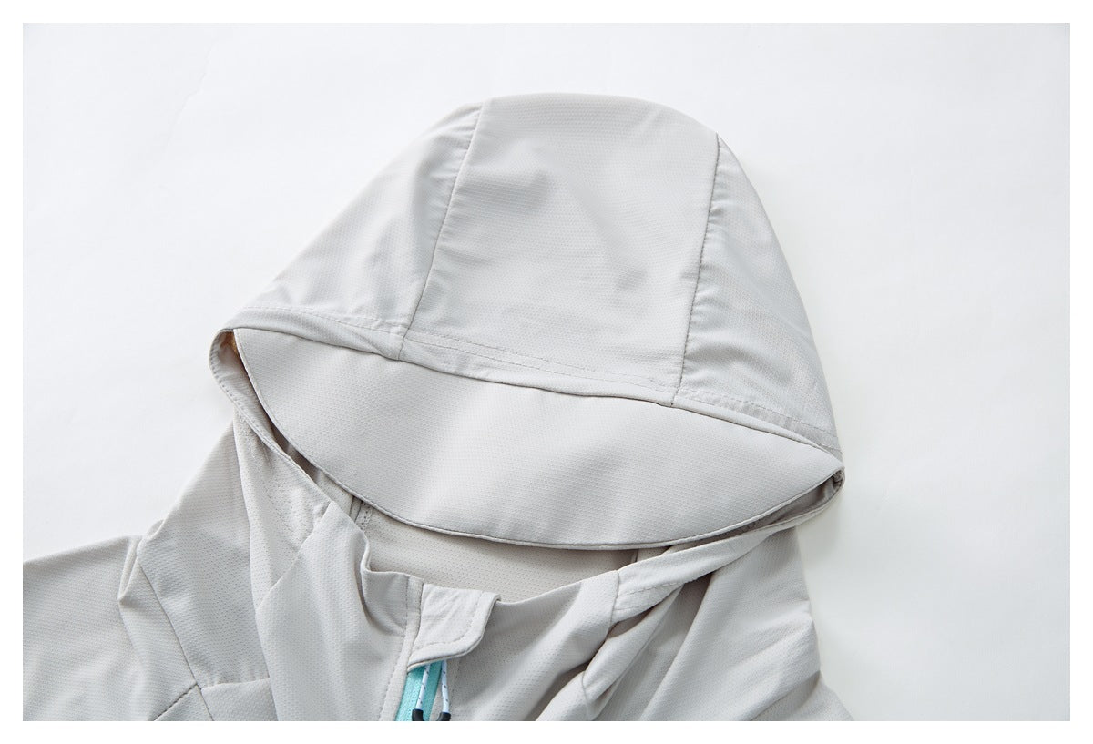 Close-up of the light gray jacket's hood, broad brim, and turquoise zipper cord.