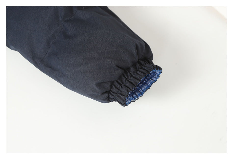 Close-up of a dark navy jacket sleeve with a gathered elastic cuff and plaid lining visible.