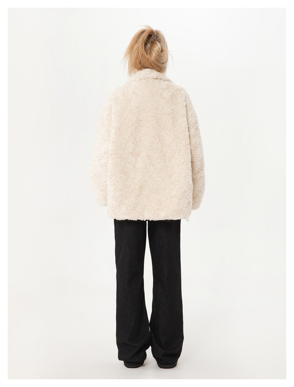Full-length rear view of a model wearing an ivory textured coat with black wide-leg pants.