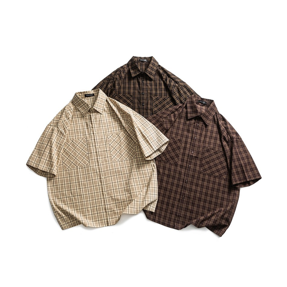 Three short-sleeve button-up plaid shirts laid flat: beige, dark brown, and deep brown, each with two chest pockets.