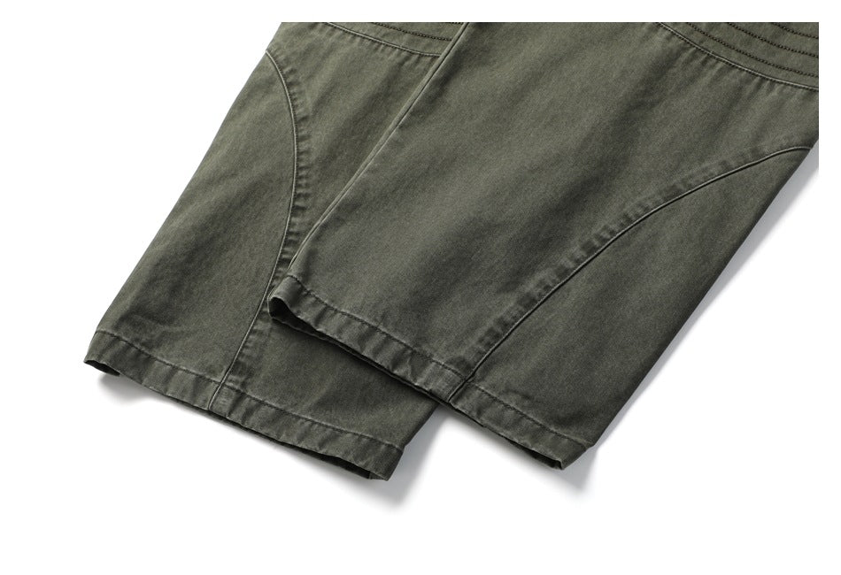 Close-up of the pants' lower legs and hems, showing curved seams on dark olive-gray fabric.