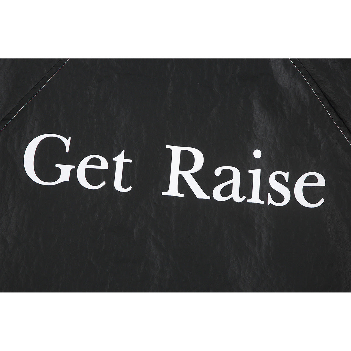 Close-up of white “Get Raise” lettering printed across the black jacket.