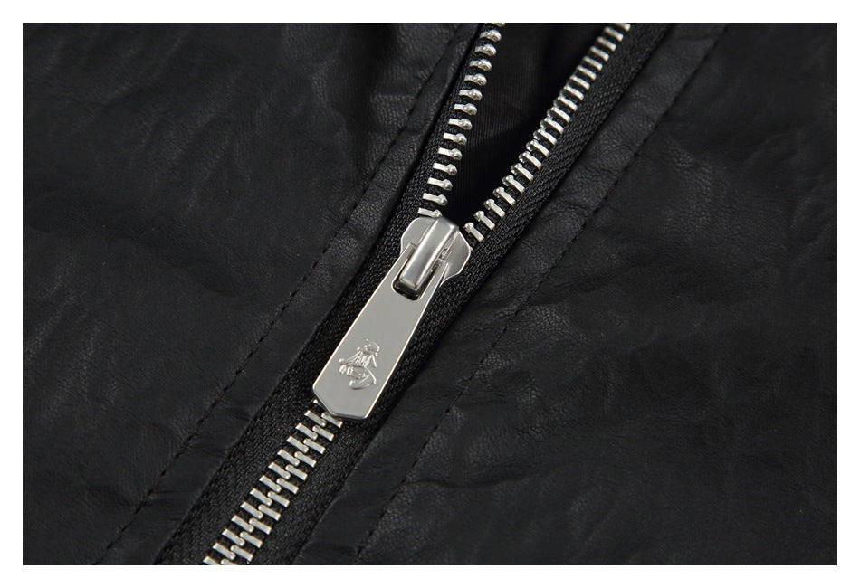 Close-up of a silver zipper and pull on the black jacket.
