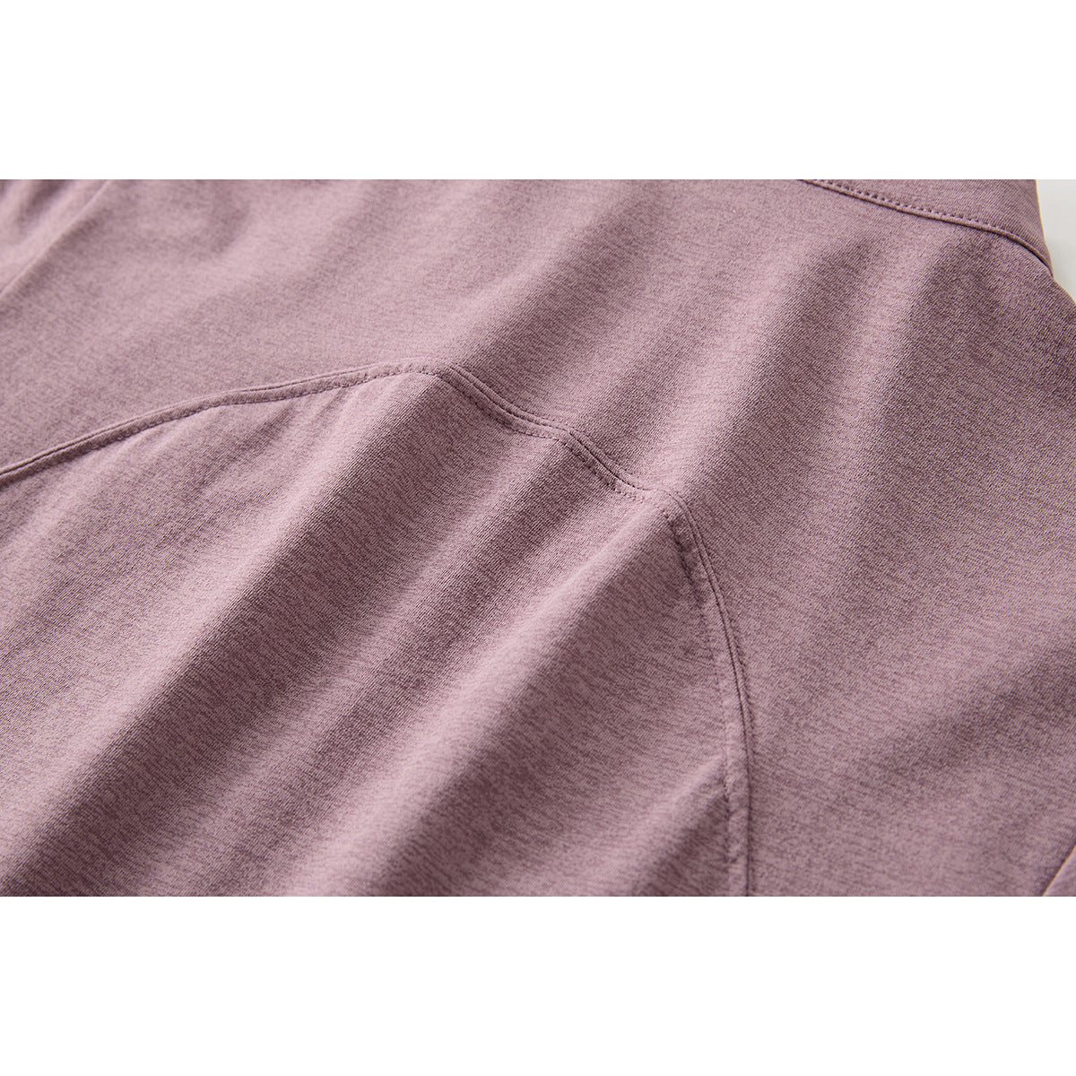 Close-up of the mauve top's curved stitched panel seams and fabric surface.