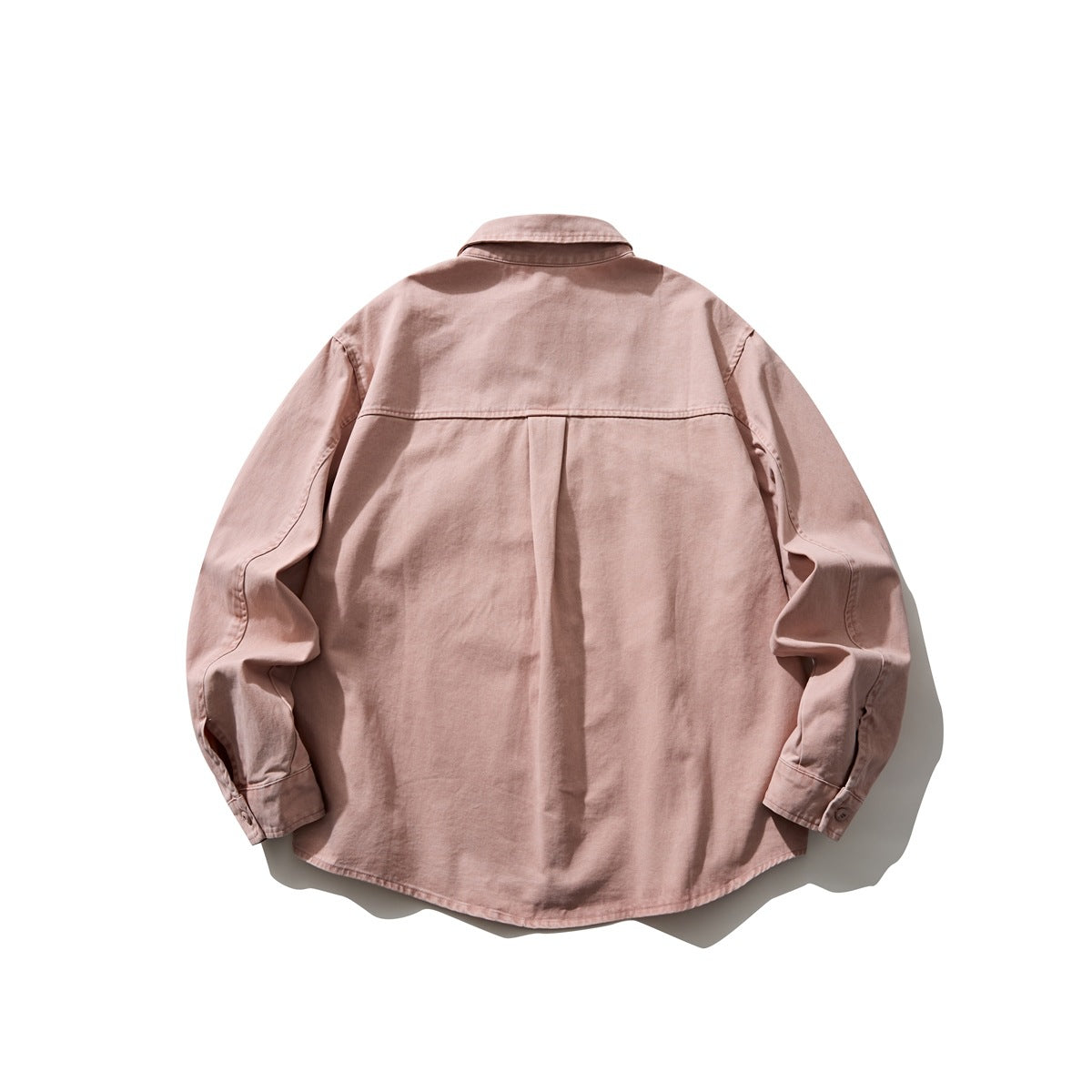 Back view of a dusty pink long-sleeve button-up shirt with a center pleat and curved hem.