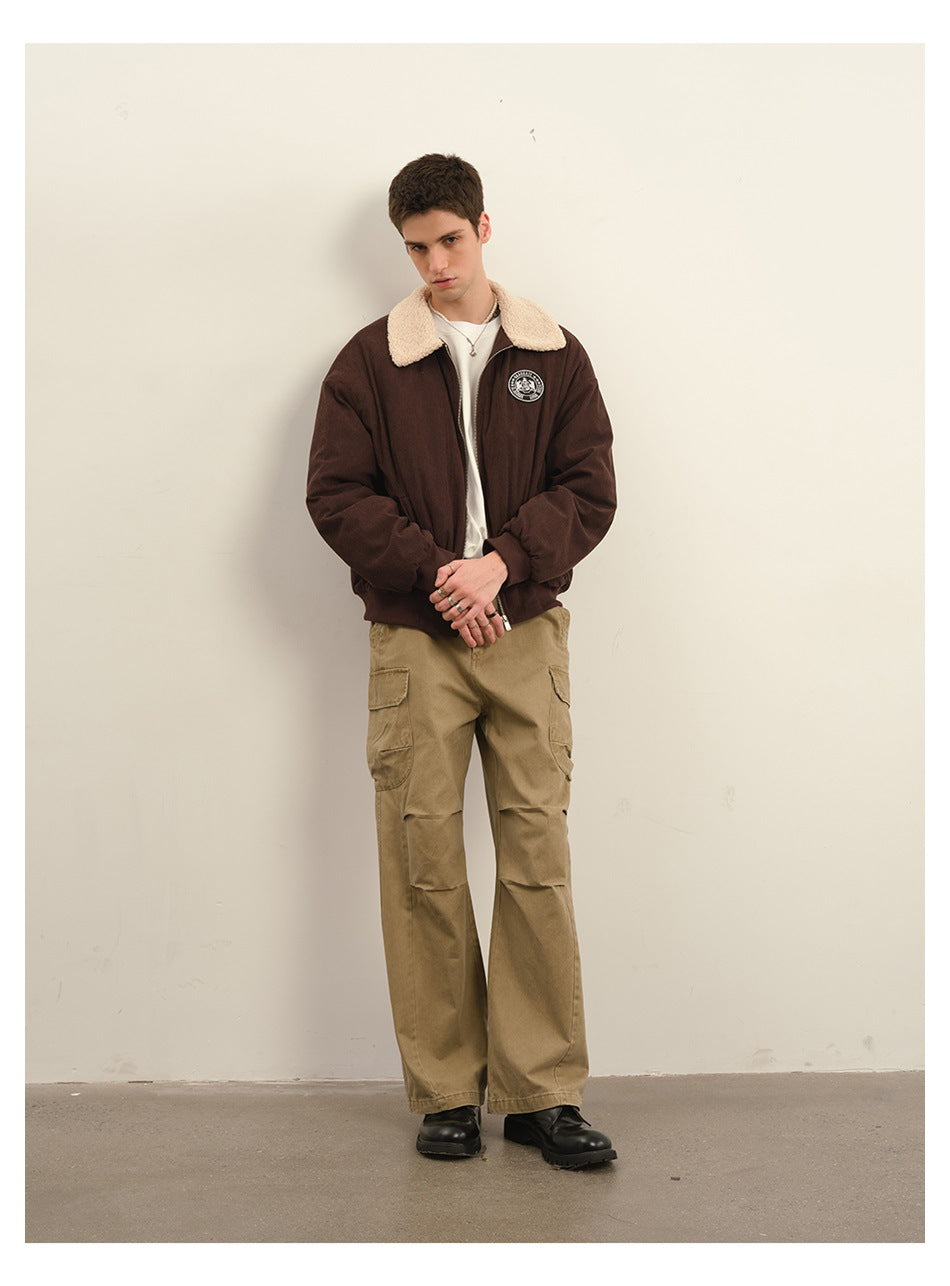 Model wearing khaki cargo pants with a brown jacket with a fleece-like collar and black boots