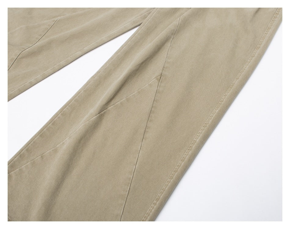 Close-up of the beige pants’ wide leg, showing the side seam and hem stitching.