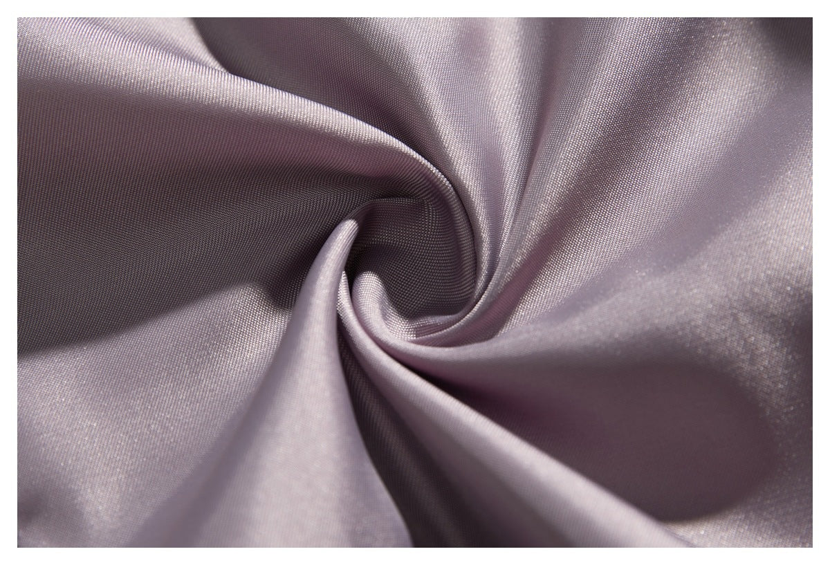 Close-up of lustrous lavender-gray fabric gathered into soft folds.