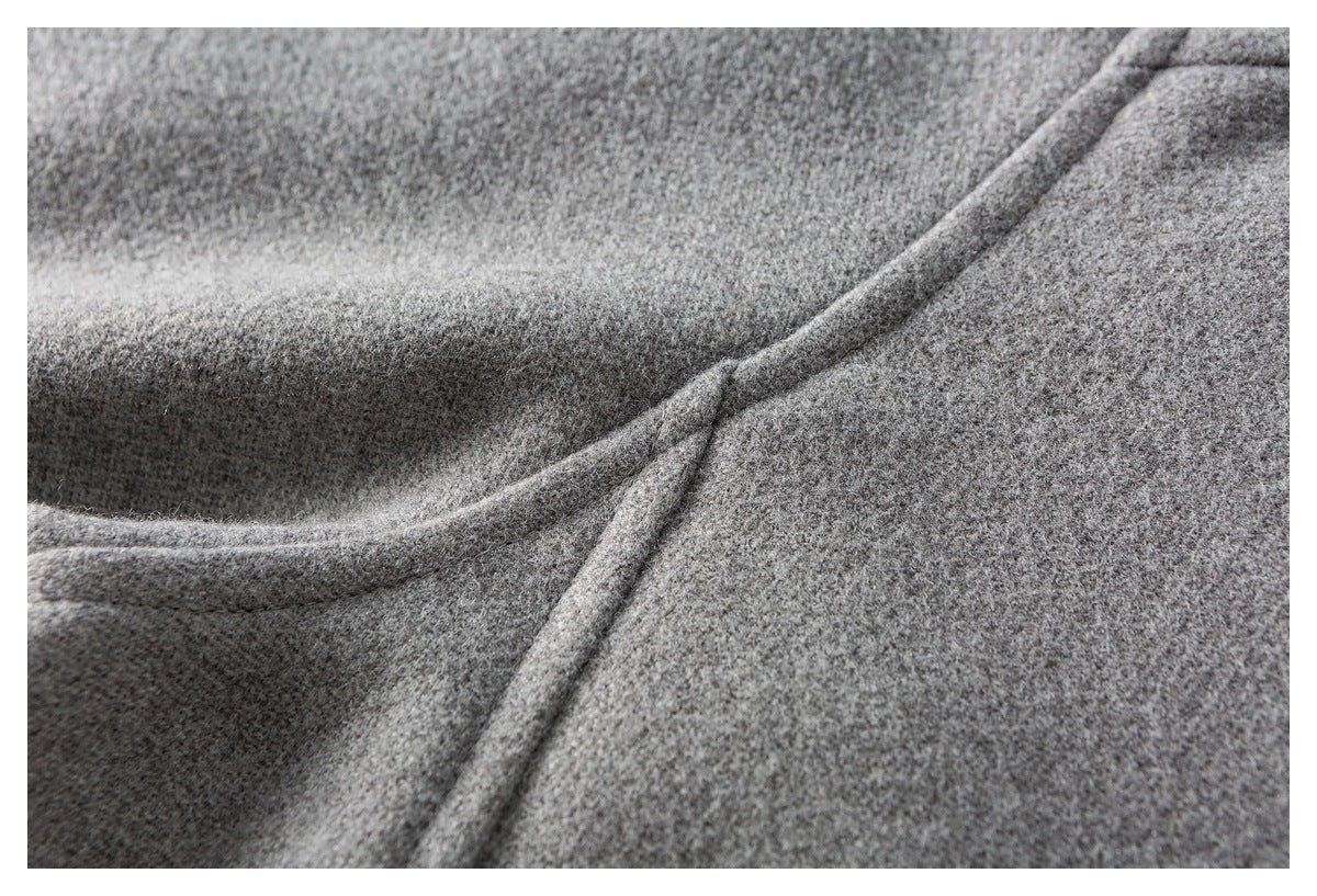 Close-up of gray mottled fabric and a curved raised seam.