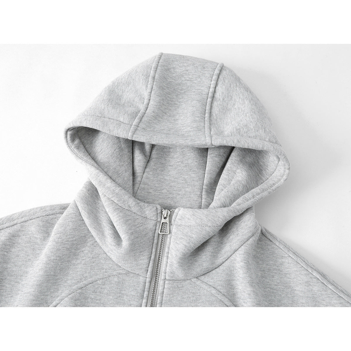 Close-up of the light gray hood and upper front of a zip-up hoodie.